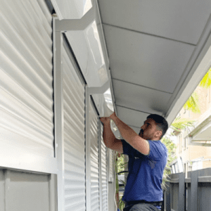 man fitting roller shutter